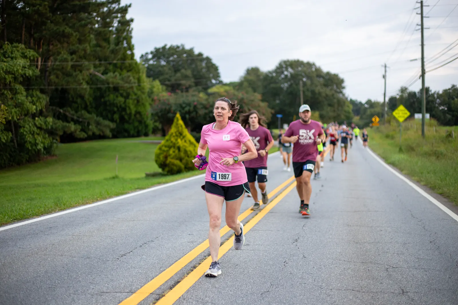 Runners following the yellow center line on the 5K course
