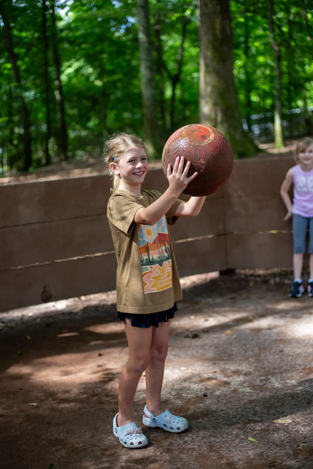 Camper holding a ball