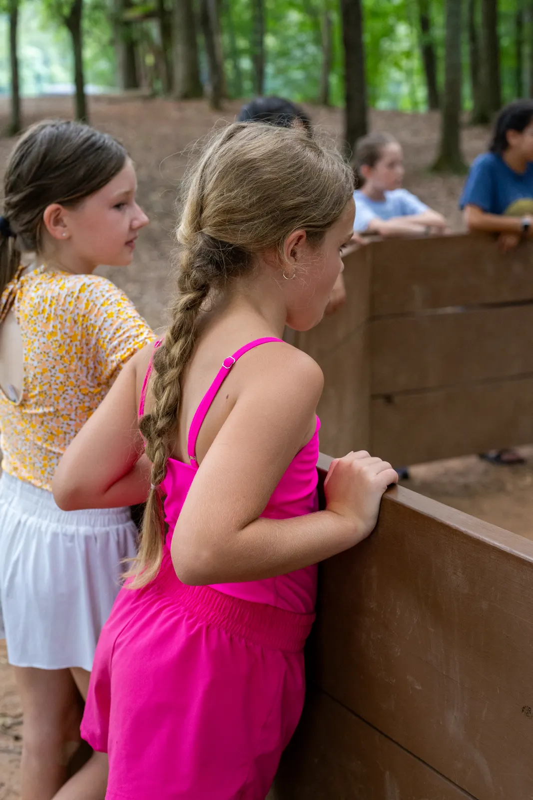 Two campers at a wooden wall