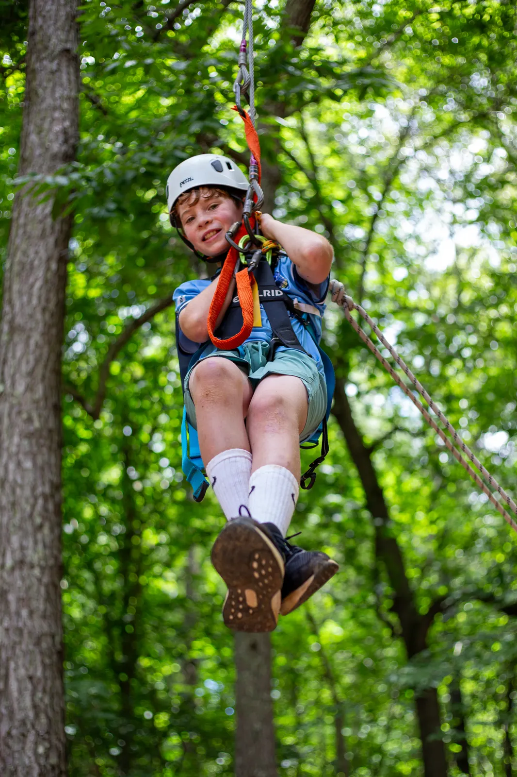 Camper riding the zipline