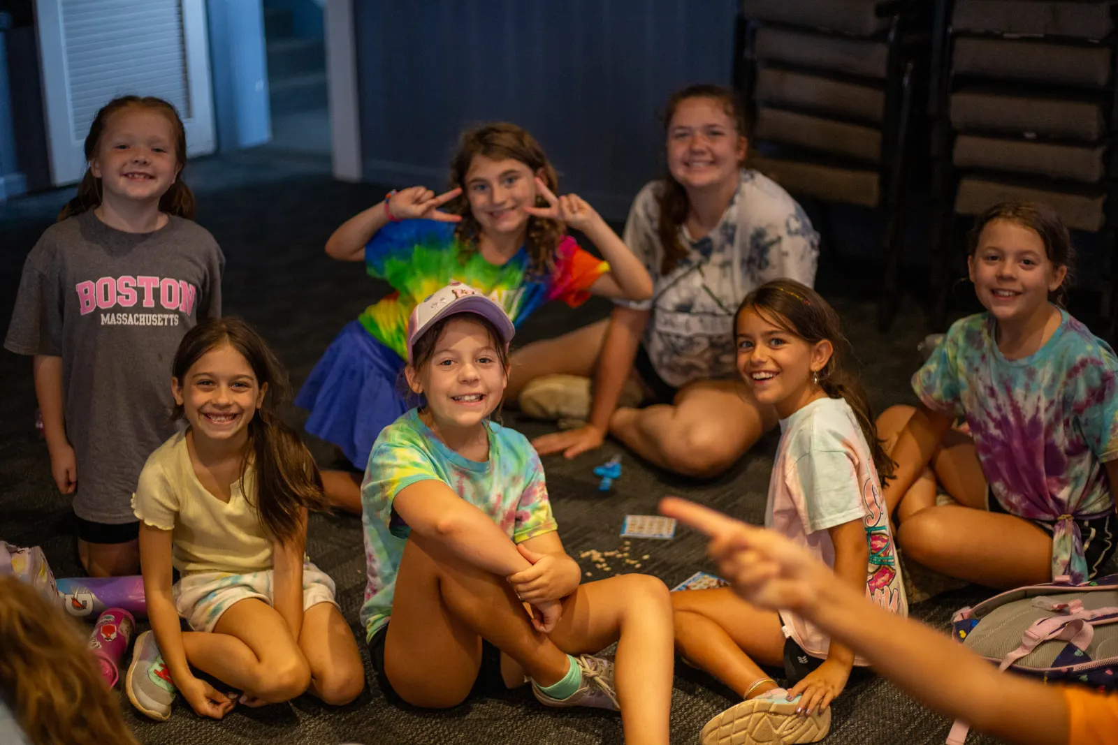 Campers and a counselor sitting together indoors