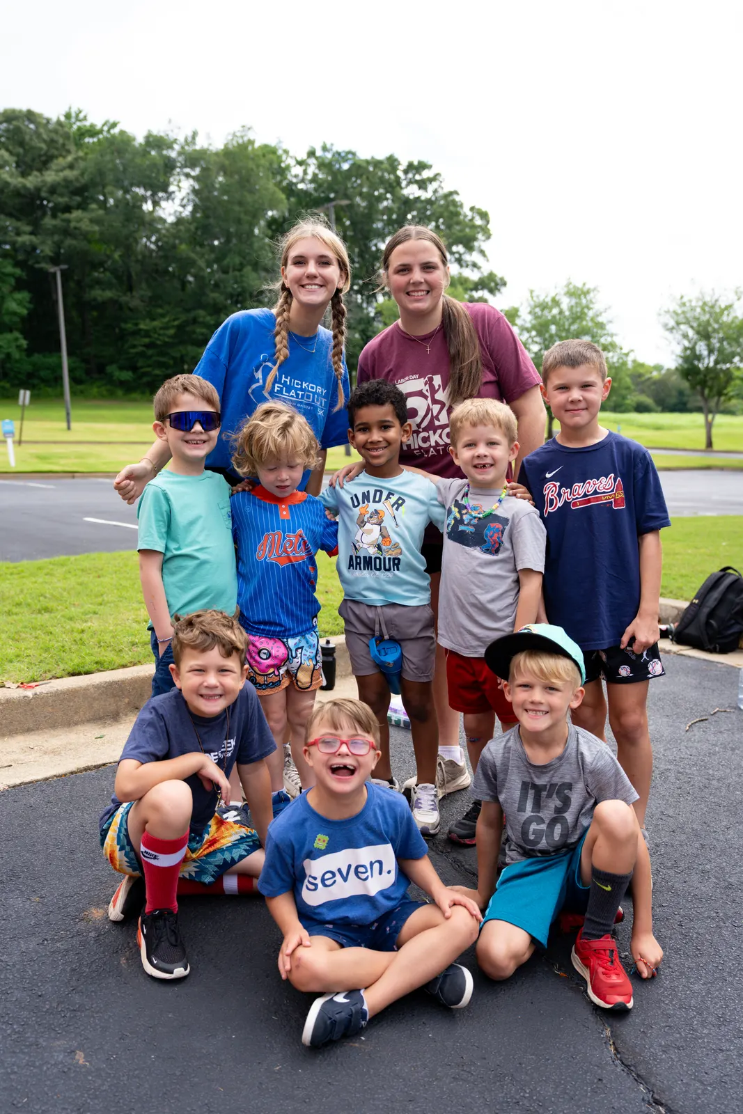Campers and counselors posing on the pavement
