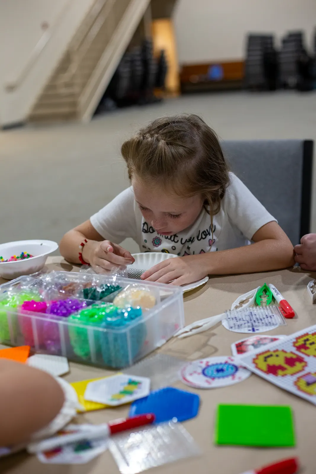 Camper making a bead craft
