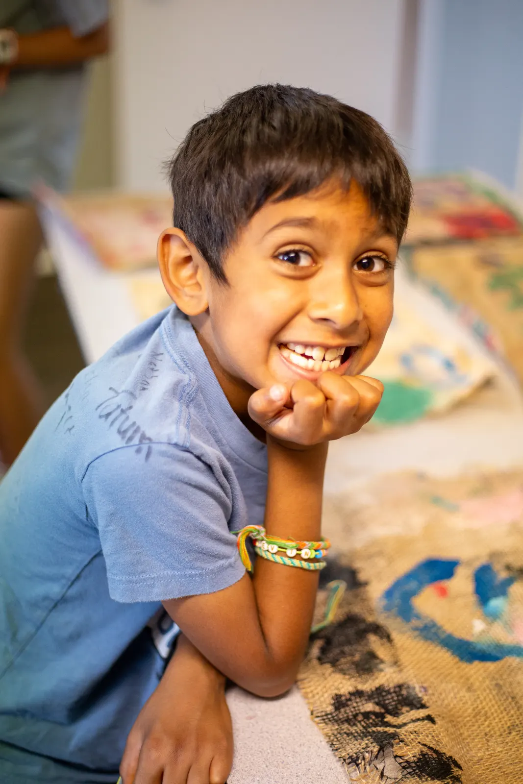 Camper smiling at the craft table