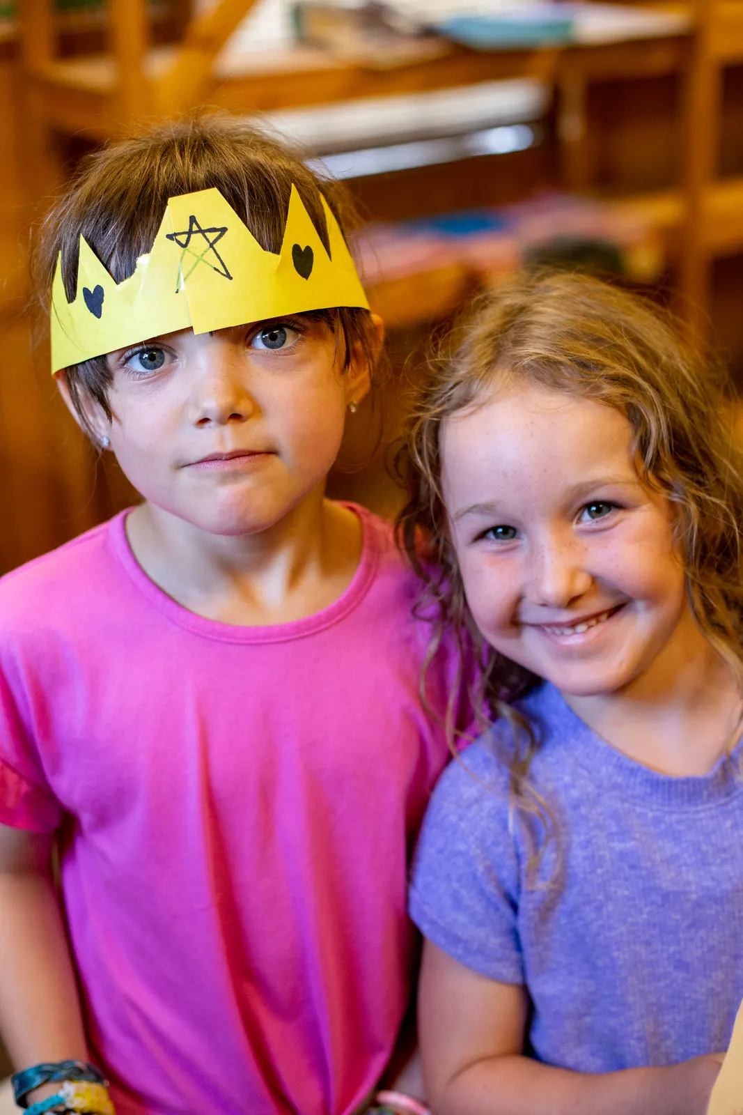 Camper in a paper crown with a friend