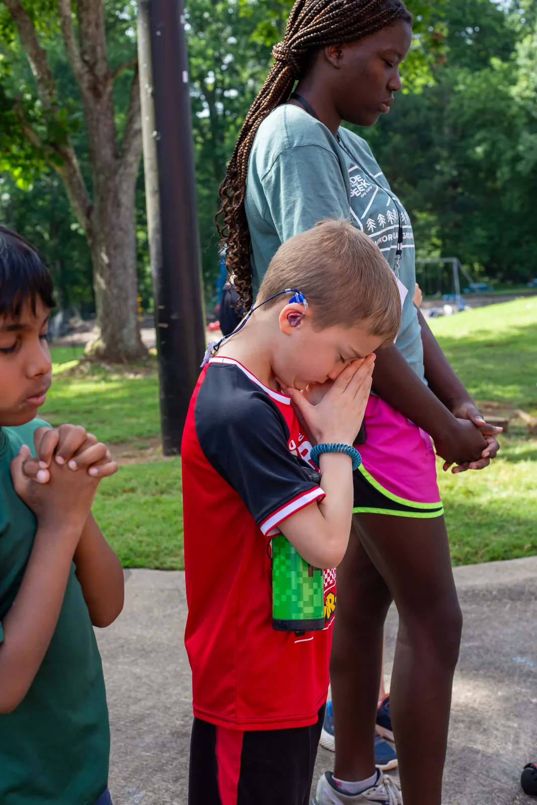 Camper praying with hands folded