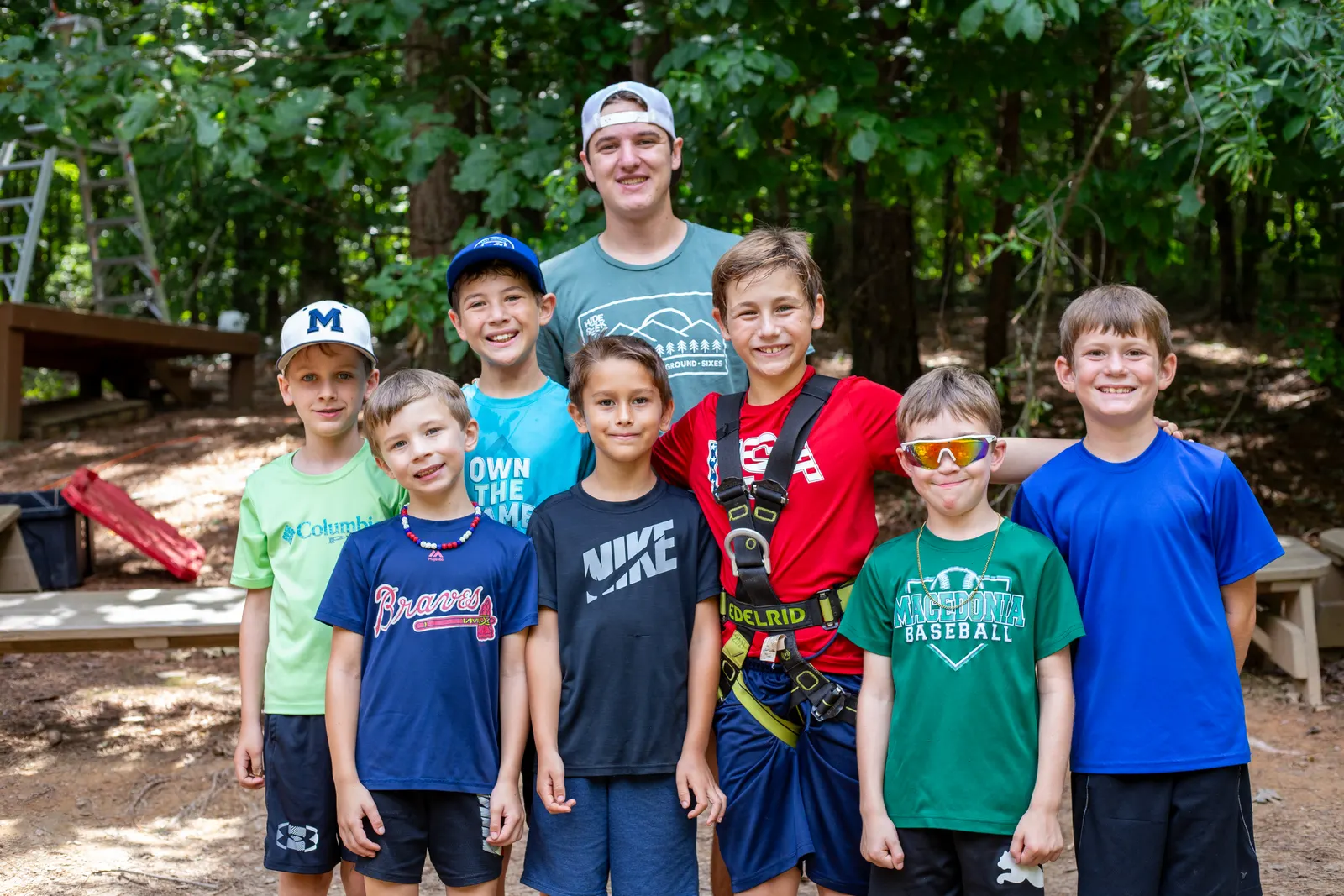 Counselor with a group of boys in the woods