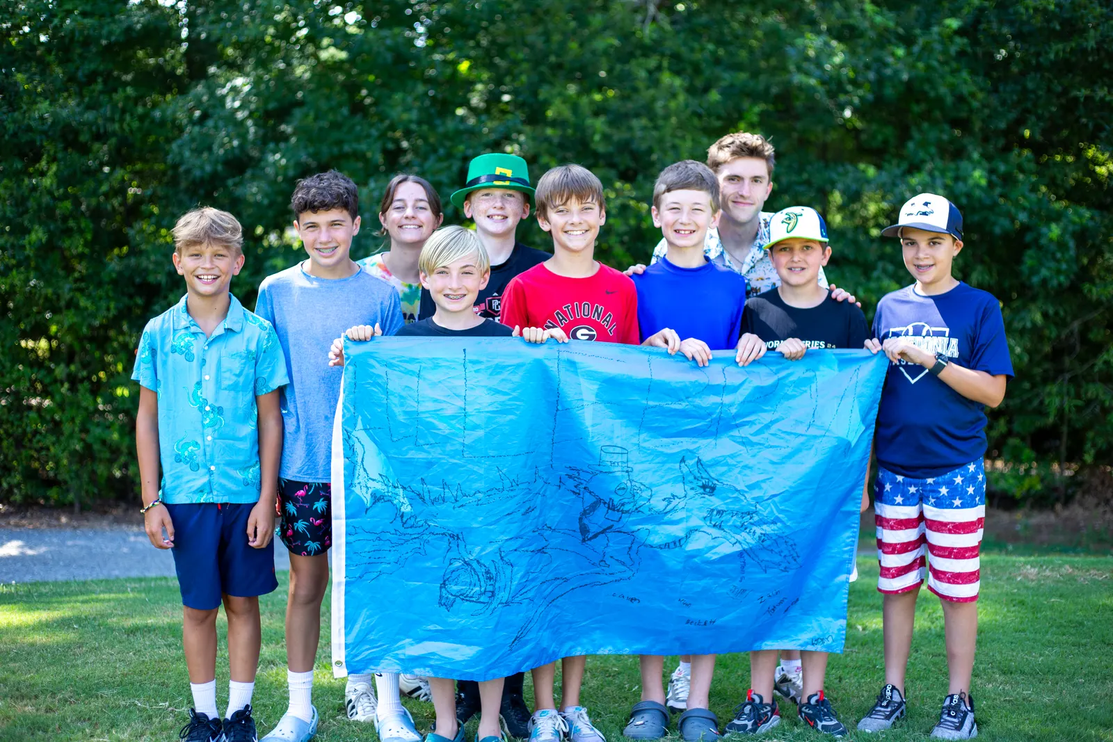 Campers holding a painted banner