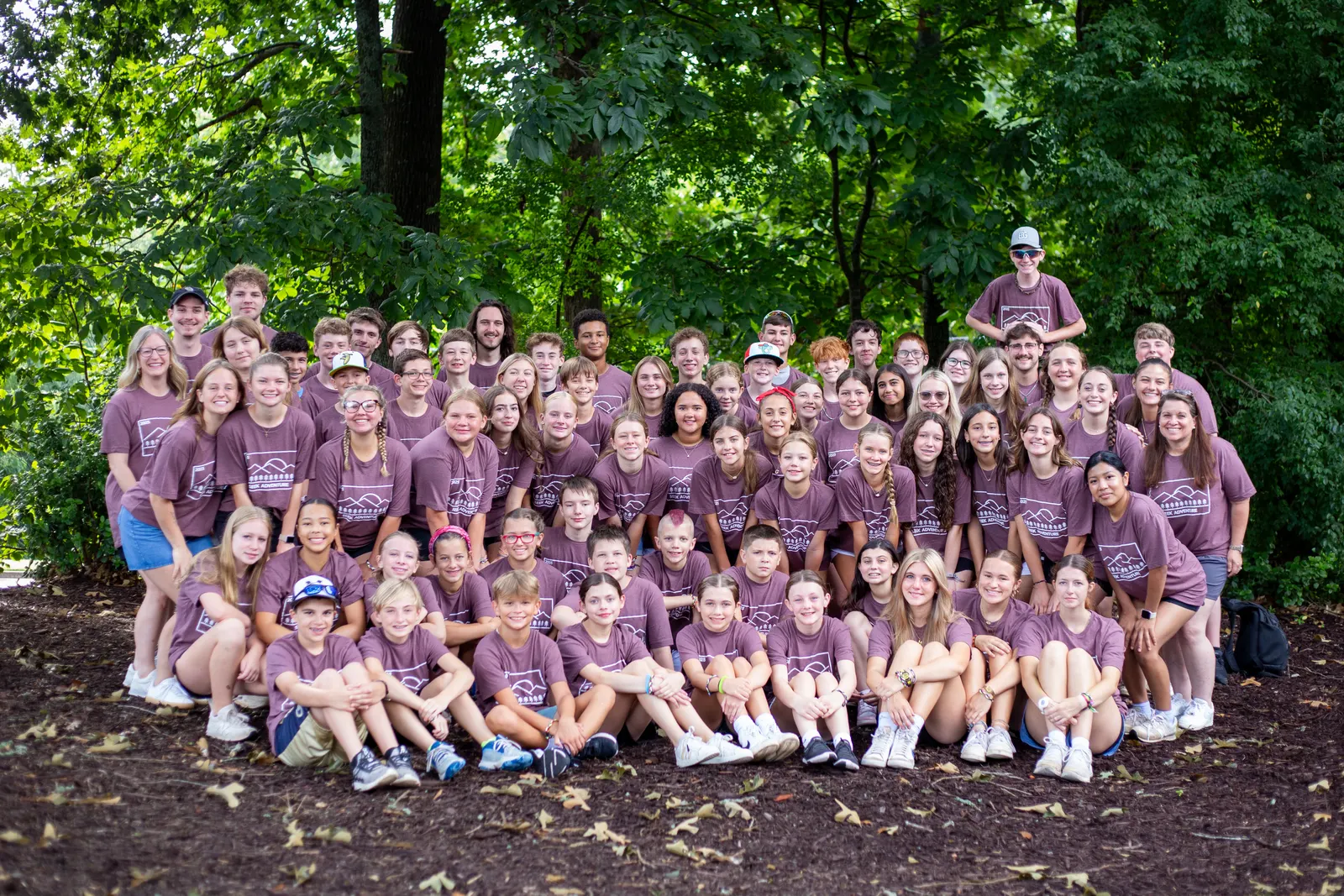 Large group of campers in matching purple shirts