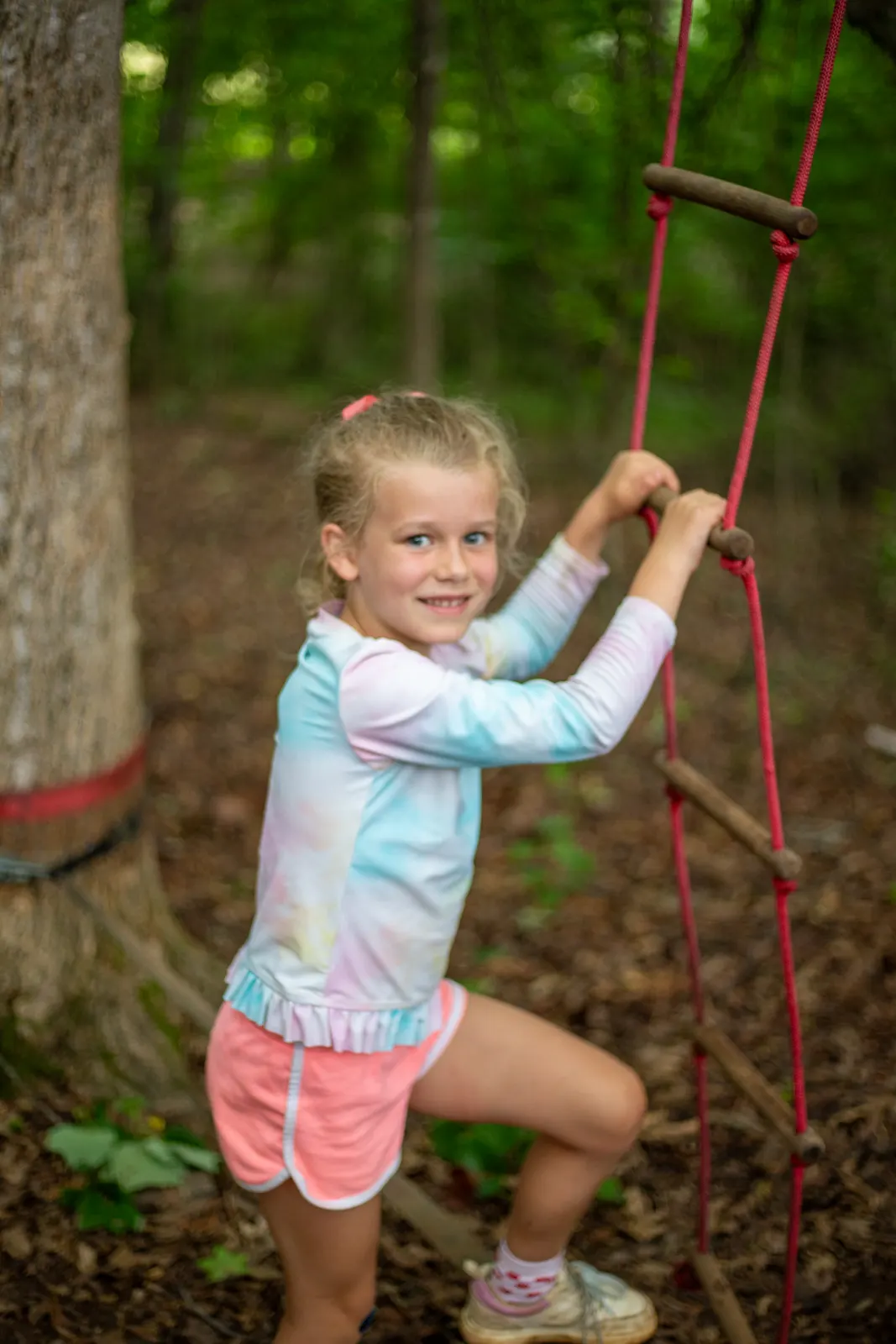 Camper climbing a rope net