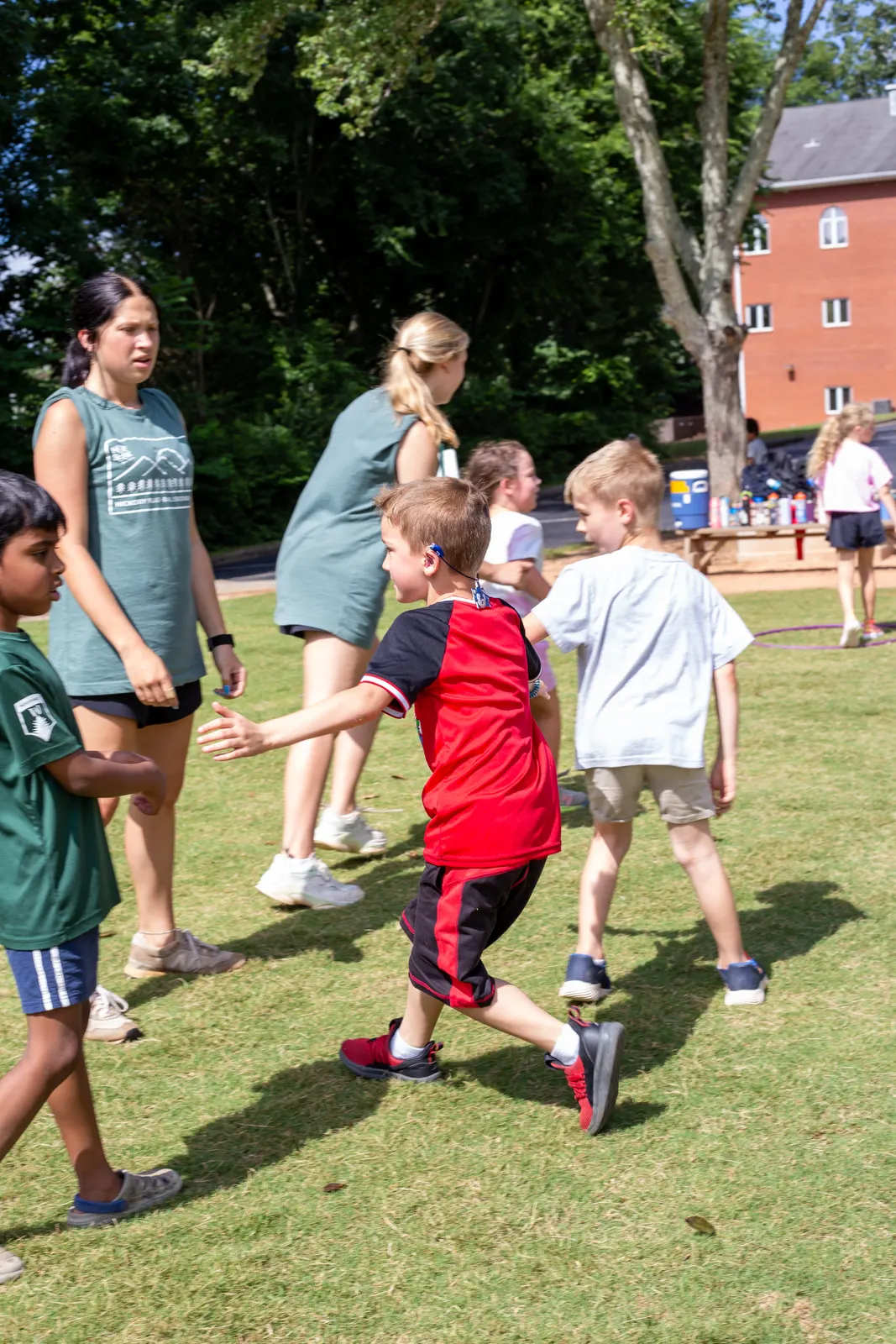 Campers and counselors walking across the field