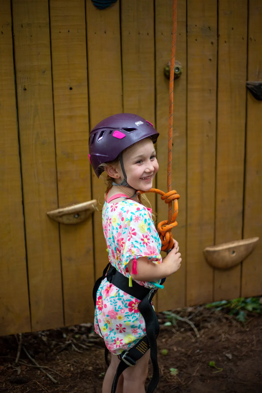 Camper in a helmet at the rock wall